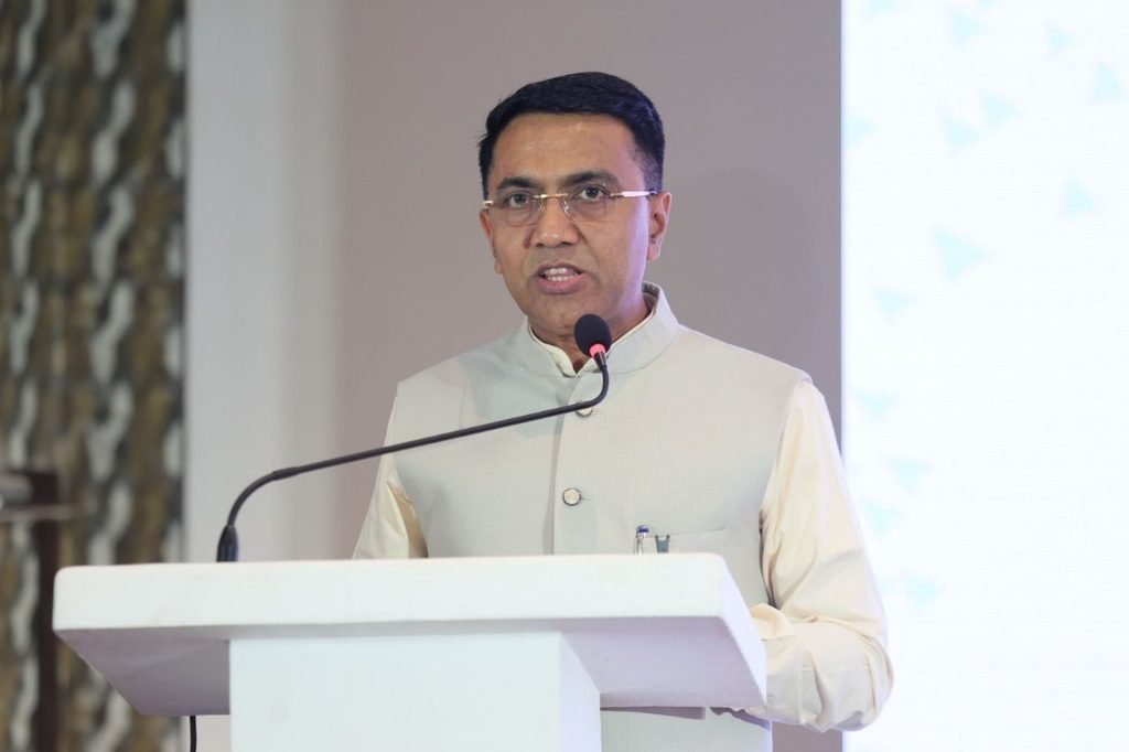 Goa Chief Minister Dr. Pramod Sawant standing on stage with government officials and German GIZ delegates holding up clean energy policy booklets at a workshop in Miramar, Panaji.