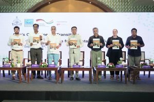 Goa Chief Minister Dr. Pramod Sawant standing on stage with government officials and German GIZ delegates holding up clean energy policy booklets at a workshop in Miramar, Panaji.